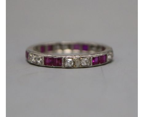 A white metal, ruby and diamond set full eternity ring, size M.