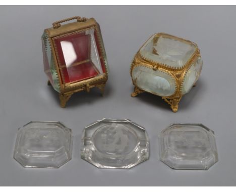 Two French gilt metal and glass trinket boxes and three intaglio glass dishes