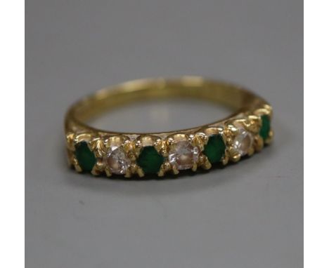 A modern 18ct gold, emerald and diamond half-eternity ring, size M/N.