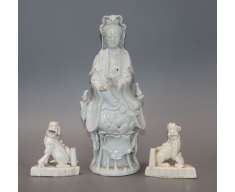 A Chinese blanc de chine figure of Guanyin and a pair of lion dog joss-stick holders, faults and a Chinese porcelain figure o