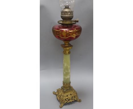 An ormolu and onyx oil lamp with cranberry reservoir
