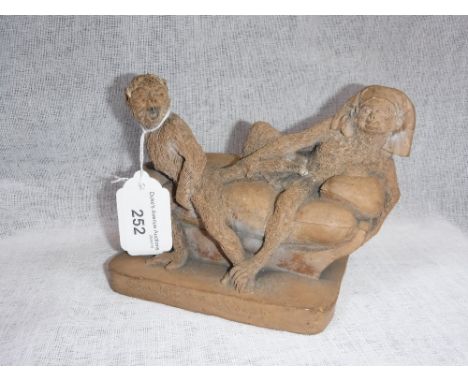 A FRENCH TERRACOTTA 'SINGERIE' FIGURE 'Chastele de Joseph', two monkeys on a sofa