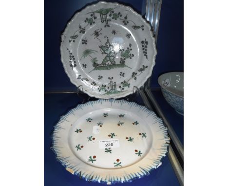 A DELFTWARE PLATE decorated with flowers and another similar