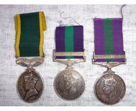 A GEORGE V TERRITORIAL EFFICIENCY MEDAL and two similar medals;  14497748 PTE.D. LEGGETT. E. YORKS. (REPLACEMENT), and  53361