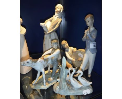 A COLLECTION OF FOUR NAO FIGURES including a boy with a calf (4)