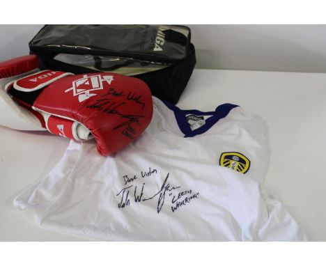 A pair of boxing gloves and a Leeds United football shirt signed by Josh Warrington 'Leeds Warrior'. 