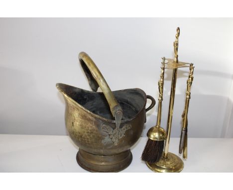 A vintage brass coal bucket and fireside tools 