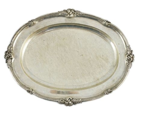 A William IV oval silver meat dish by William Kerr Reid, with reeded foliate border and engraved armorial, London, 1831, leng