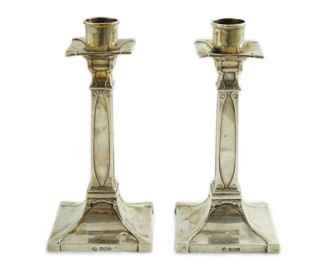 A pair of George V Arts &amp; Crafts silver candlesticks, by William Hutton &amp; Sons, with stylised faux stud work decorati