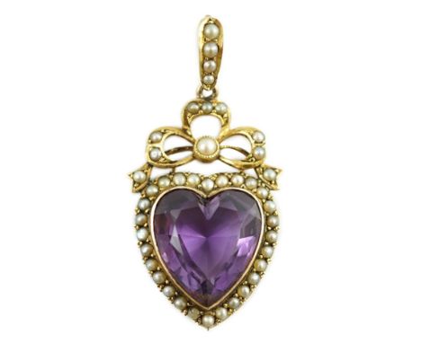 A late Victorian gold, heart shaped amethyst and seed pearl set drop pendant, overall 46mm, gross weight 7.4 grams.***CONDITI