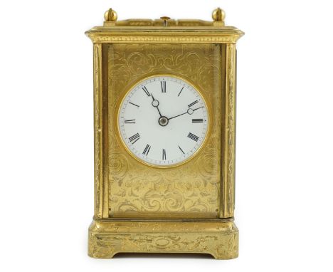 A late 19th century French gilt brass repeating carriage clock, with floral scroll engraved case and enamelled Roman dial, mo