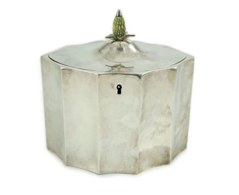 A George III oval tea caddy, by Henry Chawner, of bats wing oval shape, with carved stained ivory pineapple finial, London, 1