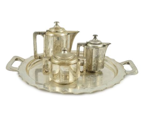 A 20th century Portuguese Art Deco three piece 833 standard silver tea set with two handled tea tray, of inswept panel form, 