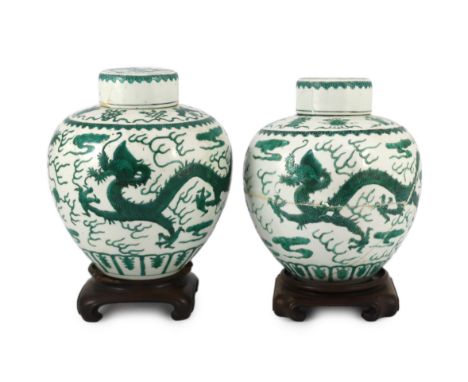 Two similar Chinese green enamelled ‘dragon’ jars and covers, Daoguang mark and period (1821-50), each shoulder painted with 