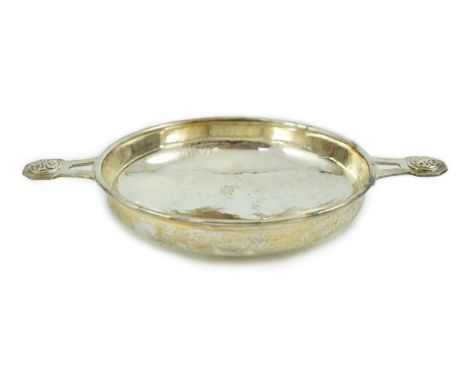 A George V Arts &amp; Crafts planished silver two handled shallow dish, by Albert Edward Jones, the pierced handles with Celt