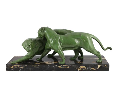 Plagner. An Art Deco patinated spelter group of two panthers, standing upon a veined marble base, length 79cm depth 25cm heig