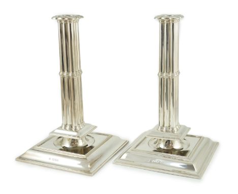 A large pair of George V silver cluster column candlesticks, by William Comyns & Sons Ltd, on broad square bases, London, 193