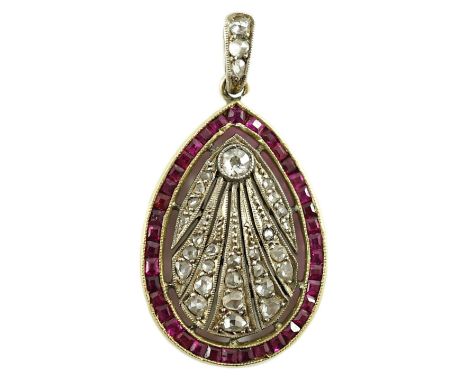 A 1920's pierced gold and platinum, millegrain set ruby and diamond oval pendant, set with round and rose cut diamonds and sq