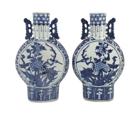 A pair of Chinese blue and white moon flasks, 19th century, each painted with birds amid flowers and rock work, the neck appl