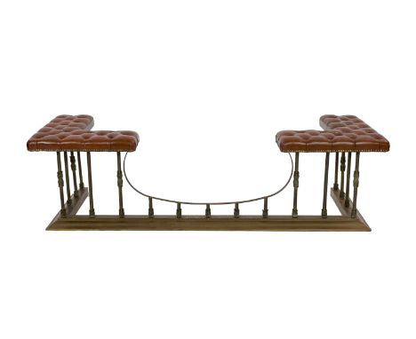 A Victorian style brass club fender, with buttoned brown leather seats and foliate motifs to the columns, width 190cm depth 6