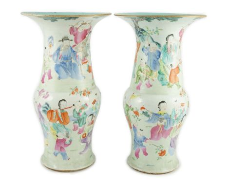 A pair of Chinese famille rose fencai ‘boys’ baluster vases, 19th century, each painted with boys holding flags, lotus and a 