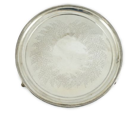 A Victorian silver salver, by Josiah Williams &amp; Co, with beaded border and engraved foliate decoration, on three scroll f