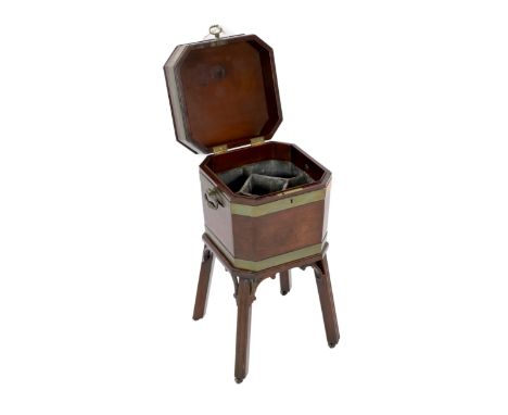 A George III brass bound mahogany cellaret, of octagonal form, with loop handles and lead lined five section interior, on sta