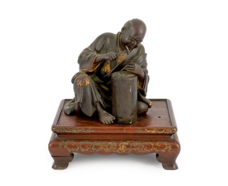 A Japanese bronze model of a sword fittings master craftsman, by Miyao Eisuke, Meiji period, the seated artist chasing a bron