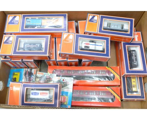 A box of Lima OO/HO gauge model rail carriages, Merit railway accessories, all boxed/packaged 