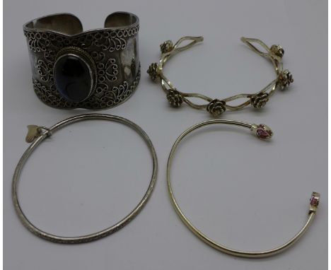 A silver cuff bangle and three other silver bangles 