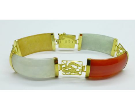A 14ct gold mounted jade bracelet, marked 'HKONG' 