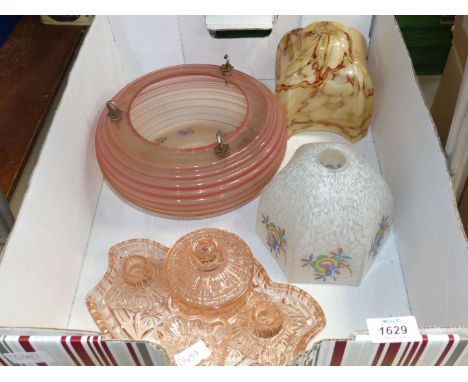 Three glass lamp shades and a pink glass dressing table set.
