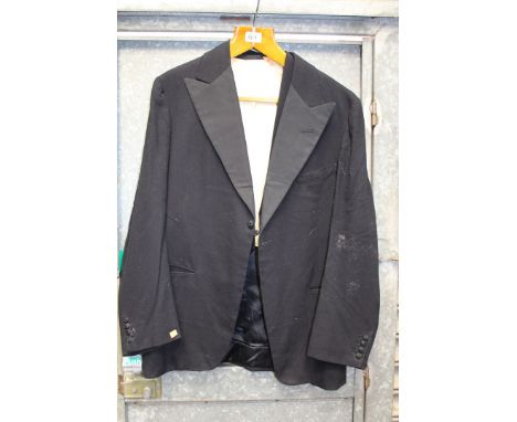 A vintage Black tie dinner jacket having one button fastening and silk lapel facings, 44" chest and a waistcoat, 44" chest.
