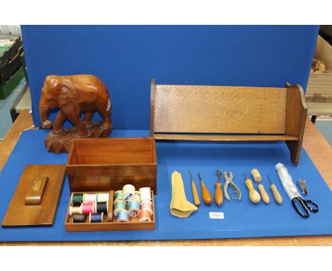 A large Oak book trough, 19" long, plus mahogany Art Deco sewing box and contents, 9 1/2" long, plus a large carved Elephant,