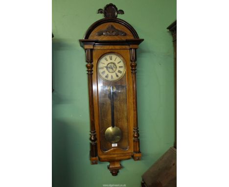 A Vienna style Walnut and other woods wall Clock with Roman numerals, fluted columns, shell pediment, key present, strikes on