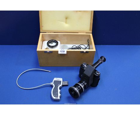 A Robot Star 35mm camera with telescope attachment plus accessories in a wooden case.