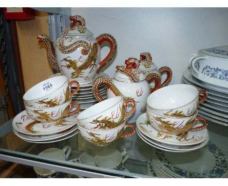 An Oriental tea service for six, white ground having dragon decoration with head of Geisha girl lithophane to cup bases. (Bre