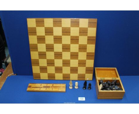 A Mahogany and satinwood cribbage board, 9 1/2" long. plus a complete boxed Chess set carved in the African taste, plus the g