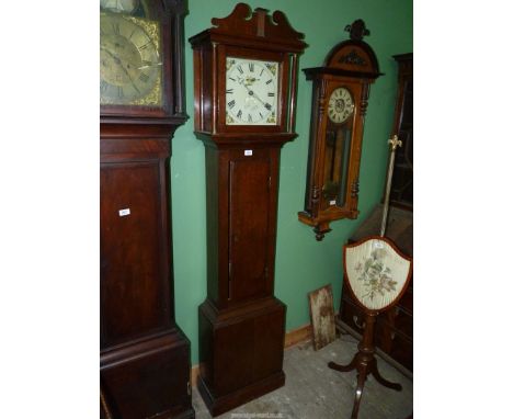 An Oak cased Longcase Clock by Carter, Salisbury, the 30 hour movement striking the hours on a bell, having a painted face wi