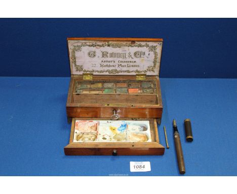 A small Artists box by G. Rowney & Co containing a white ceramic palette and various watercolour paint blocks, plus a key. To