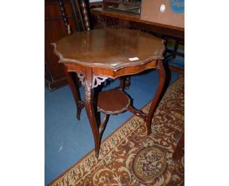 A shaped top Mahogany occasional Table standing on four shaped legs mounted by a lower shelf, 25 1/2'' diameter x 27'' high.