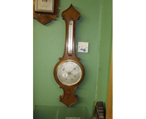 An Oak cased Aneroid Barometer with thermometer, glass cracked, 34'' long overall.