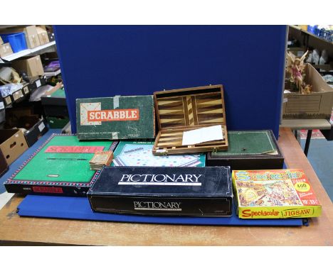 A quantity of games including; a Remy Martin 'Captains Mistress' game (boxed), Scrabble De Luxe, Pictionary, Backgammon, etc.