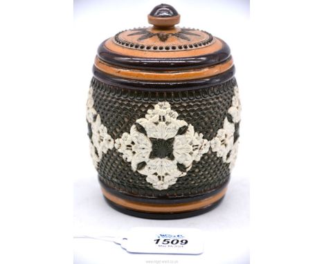 A Doulton Lambeth Tobacco jar, circa 1885, having baskets of flowers forming patterns on a fish scale ground (large repair to