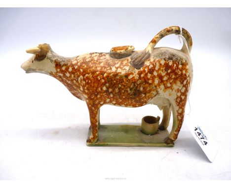 A Whieldon, circa 1820, cow creamer having pail beneath her udders. 7" x 4 1/4" tall.