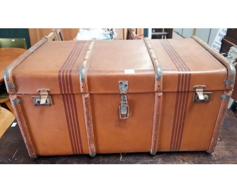 A large canvas cabin trunk, wood bound with interior shelf 