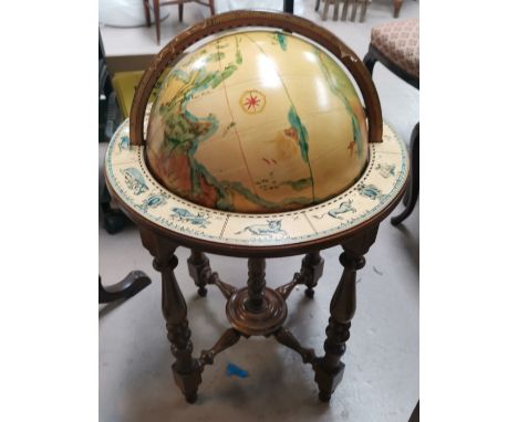A reproduction globe on stand, with hand painted effect decoration, with zodiac signs to base 
