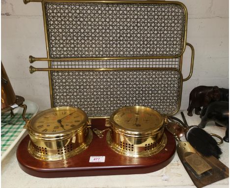 A reproduction ship's brass clock and barometer; a gilt and glass table lamp; a brass oil lamp; trivet; firescreen 