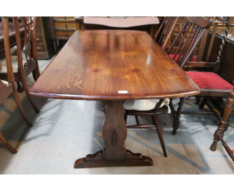 An Ercol refectory style dining table with stretcher base, 144 cm x 76 cm 