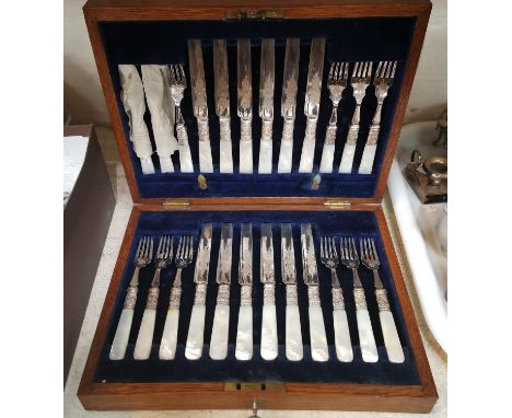 A canteen of dessert cutlery with mother-of-pearl handles, in oak case 